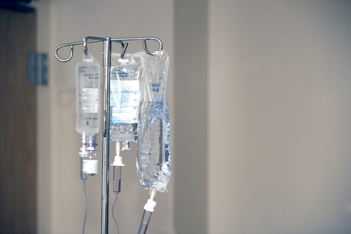 Three IV's hand on a stand in a hospital room
