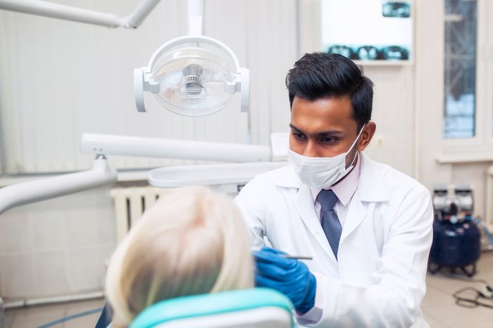 dentist examining woman's mouth
