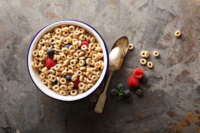 bowl of cereal O's with raspberries and blueberries