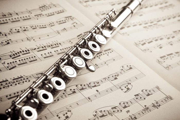 Silver flute on sheet music