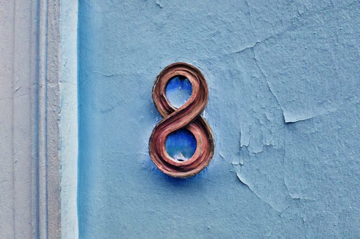 Number 8 house number on a blue wall.