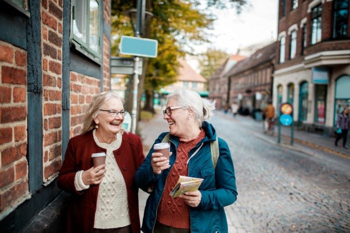 elderly women getting coffee and talking together