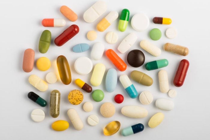 vitamins and supplements pills overhead studio gray background