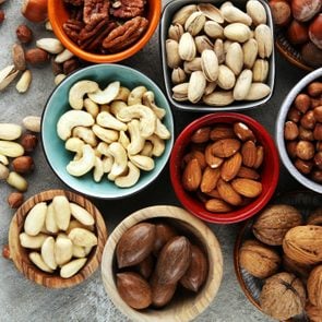 mixed nuts on grey background. Healthy food and snack. Walnut, pecan, almonds, hazelnuts and cashews