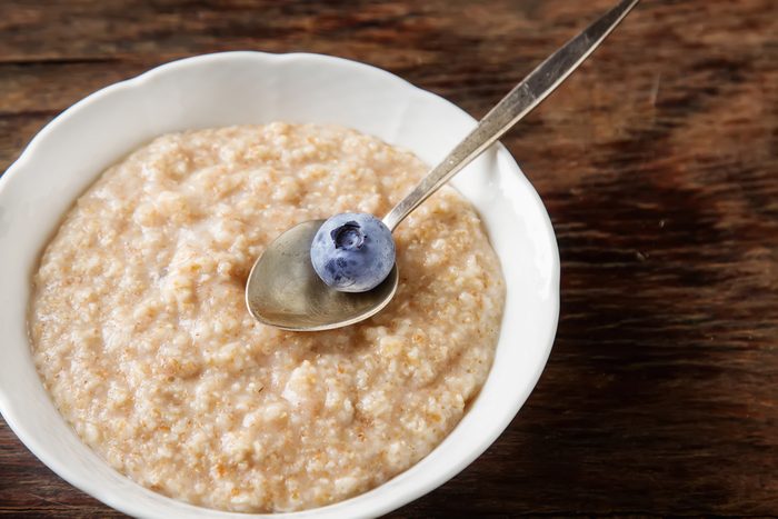 Perfect breakfast. Oatmeal with blueberries. Healthy eating for the whole family. wood background.