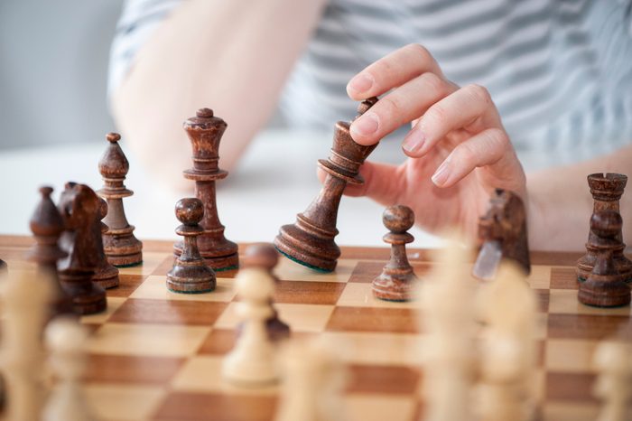 close up of woman playing chess