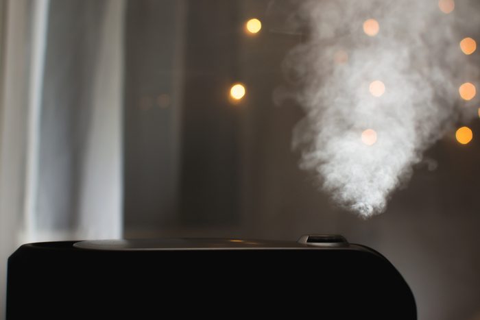 Humidifier emitting steam in a dark room