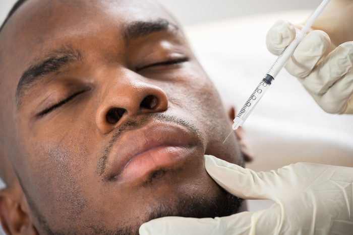man getting filler injection in face