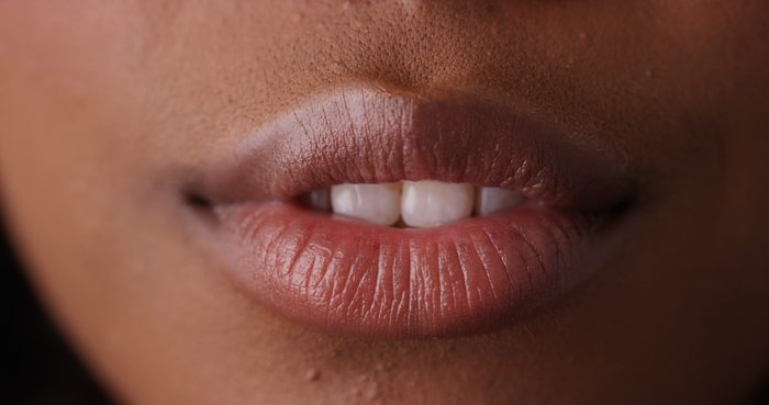Extreme close up of sensual black woman's lips on green screen