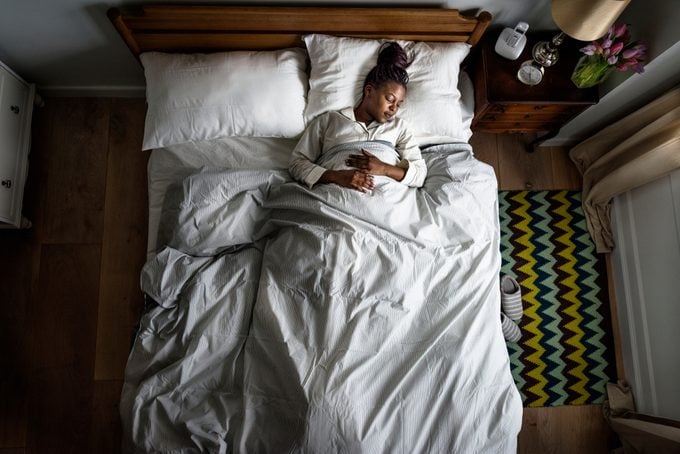African American woman on bed sleeping