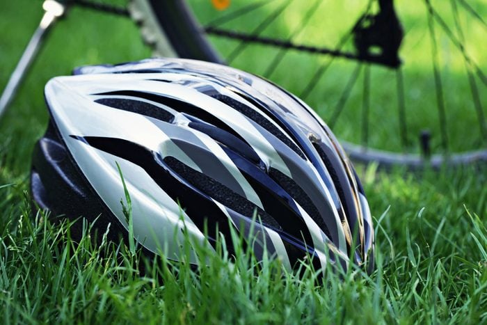 bicycle helmet on green grass - sport and leisure