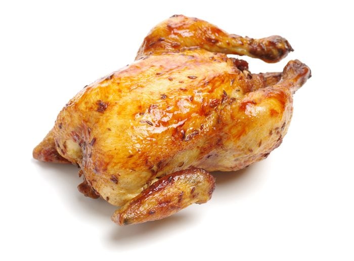 Whole roasted chicken against white background