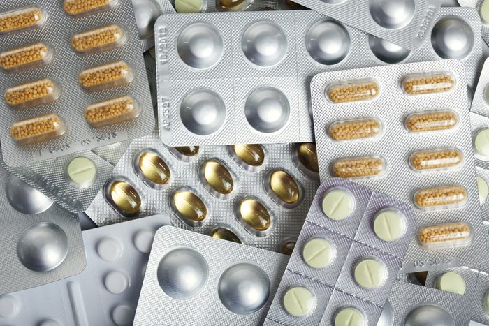 background of various blister packs with pills and capsules