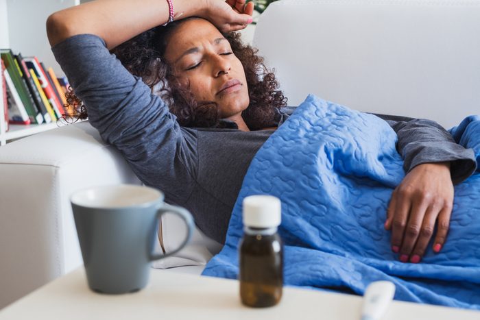 Black woman feeling sick and seasonal flu symptoms