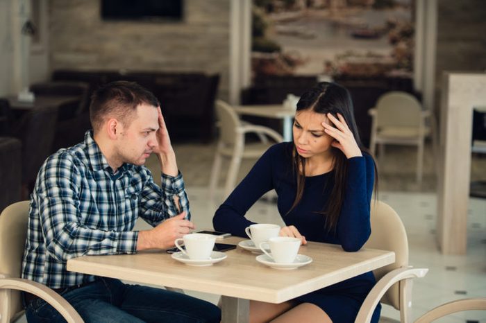 Young couple arguing in a cafe