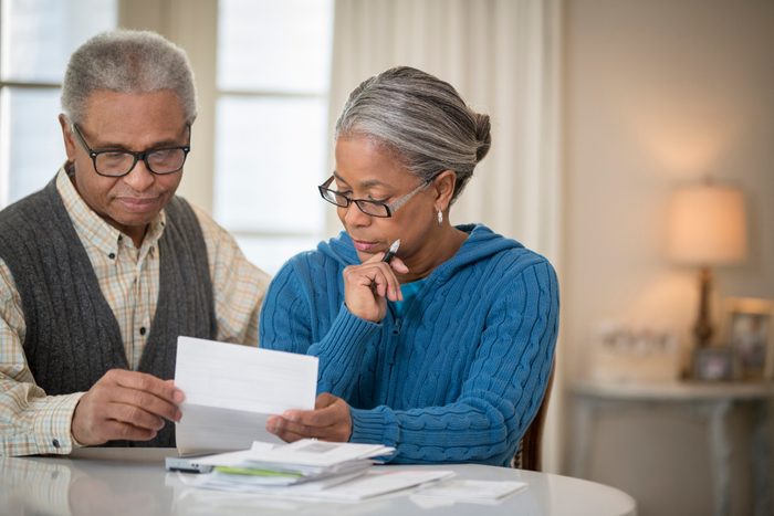 mature couple paying bills at home
