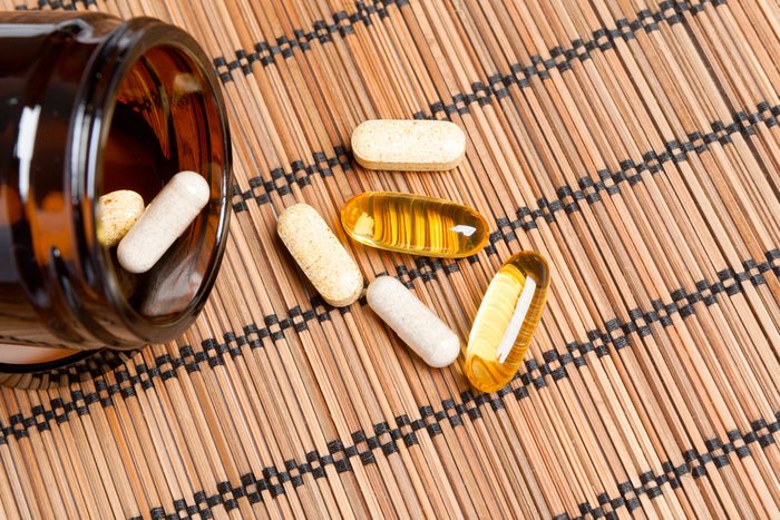 Dietary supplement. multivitamin tablets in a brown medicine bottle