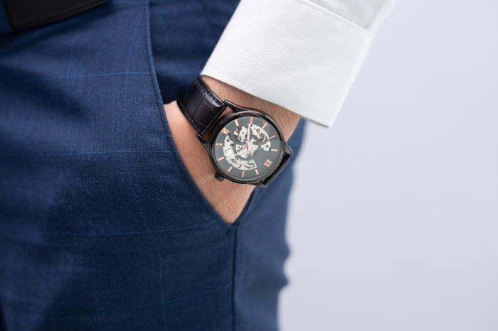 Man's hand in pocket showing wrist watch