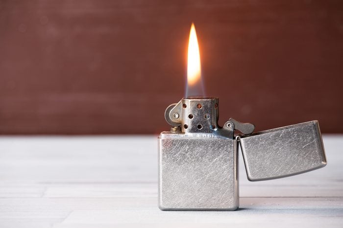 Open cigarette lighter with flame