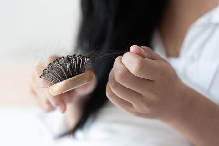 closeup of a woman brushing her hair