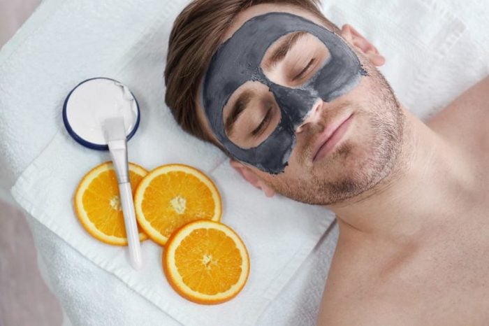 reclining man with a face mask at a spa