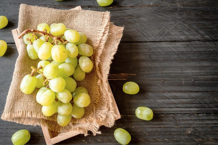 fresh green grapes on wood background