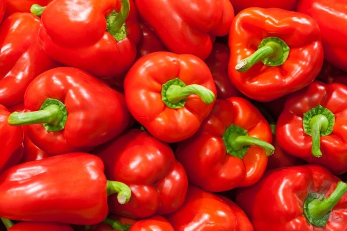 A pile of red bell peppers as background, texture