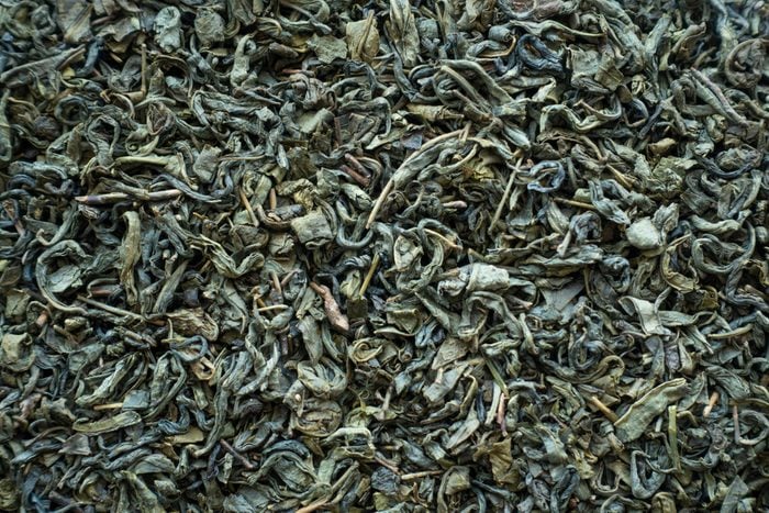 Dry green tea as background or texture top view