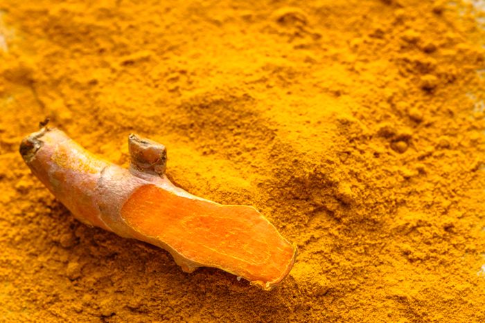 Fresh root and turmeric powder, indian spice, healthy seasoning ingredient for vegan cuisine