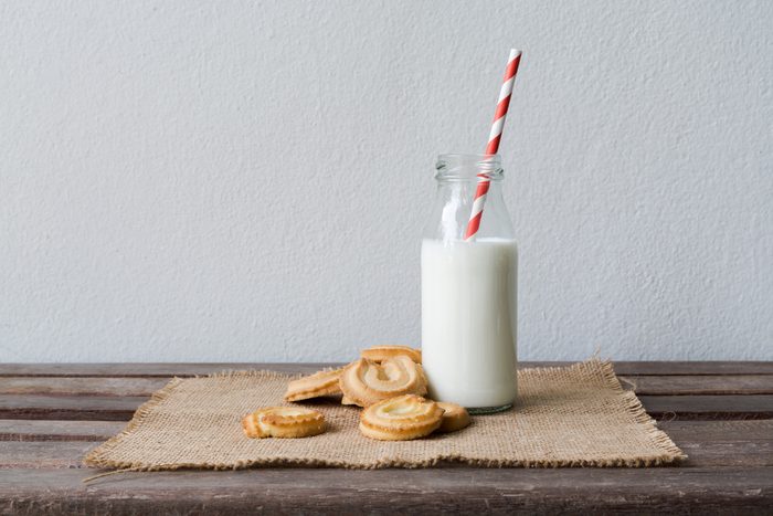 Cookies and bottle of milk on wood table