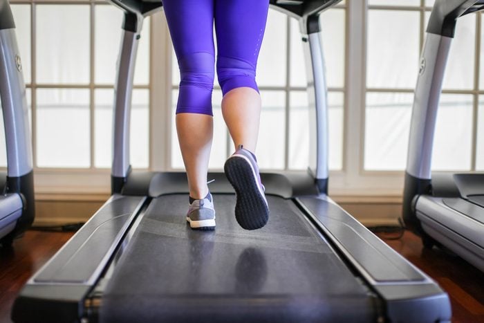 legs of woman running on treadmill in the gym which runner athletic by running shoes. Health and sport concept background, Healthy lifestyles