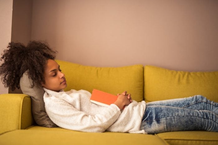 young African American black girl woman nap napping on couch
