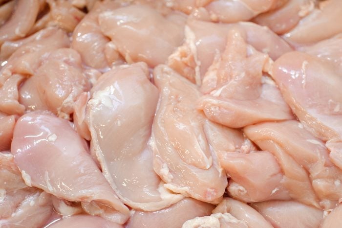 Chicken fillet. meat factory of chicken products. Butcher work.