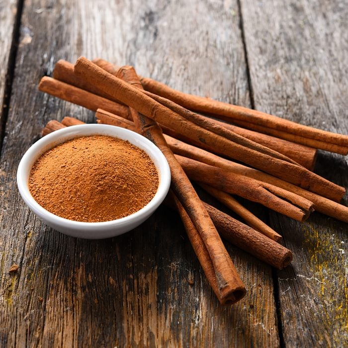 Cinnamon sticks and cinnamon powder on wood; Shutterstock ID 646377511