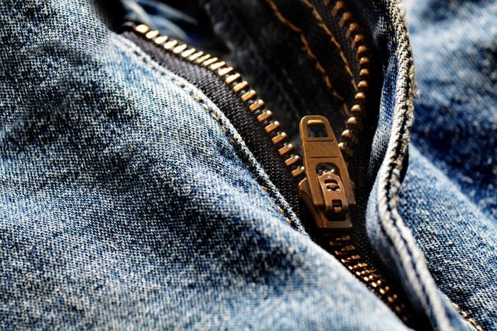 Detail of denim zipper on old worn jeans