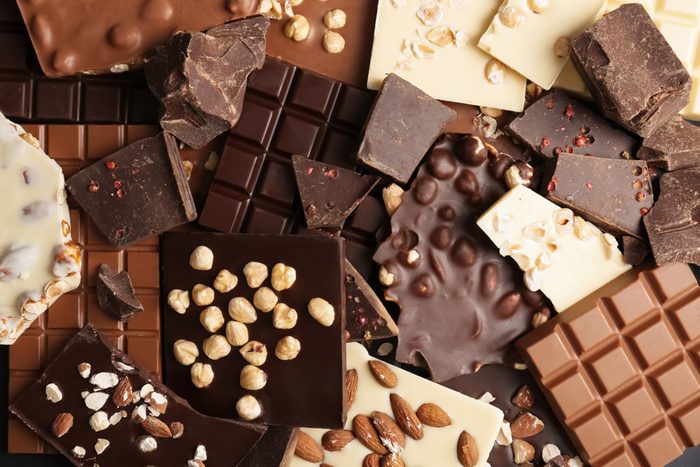 Many different delicious chocolate bars as background