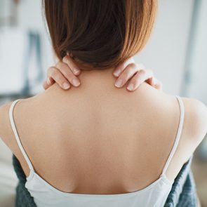 Woman with neck pain, stiff neck