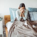 woman sick in bed with a cold