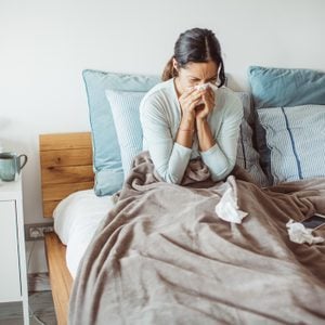woman sick in bed with a cold