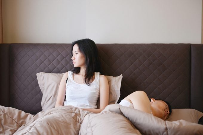 sad depressed woman thinking on bed , boring of her husband in luxury bedroom