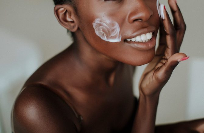 African American girl applying facial skincare product. Sexy woman face. Brutal sexy face girl. Hot babe. Erotic concept. Erotica. Passionate concept. Passion. Adult . Sensual. Sensuality