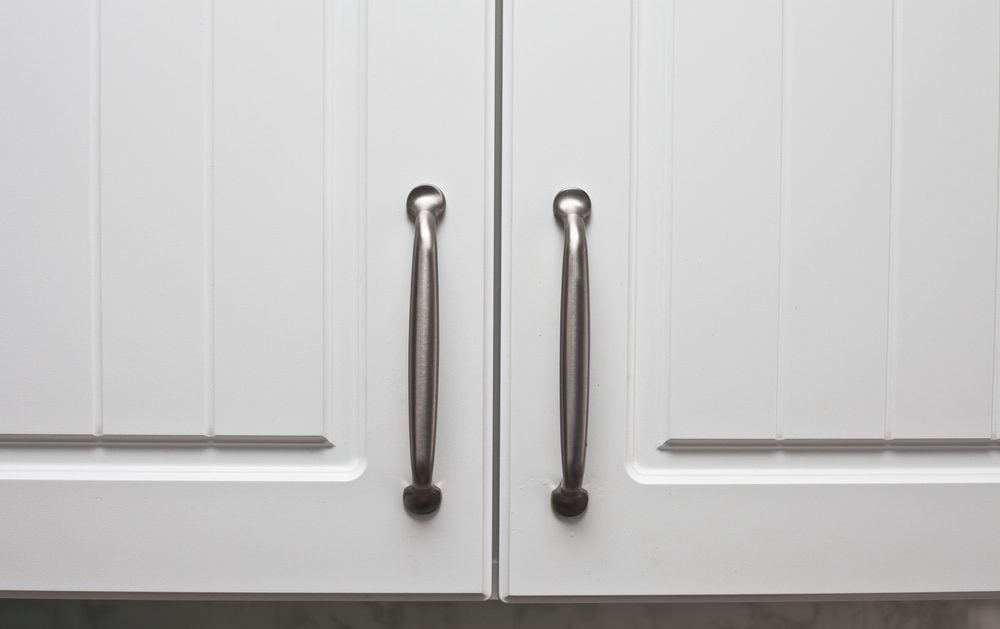 Chrome handles on a pair of wooden cupboard doors
