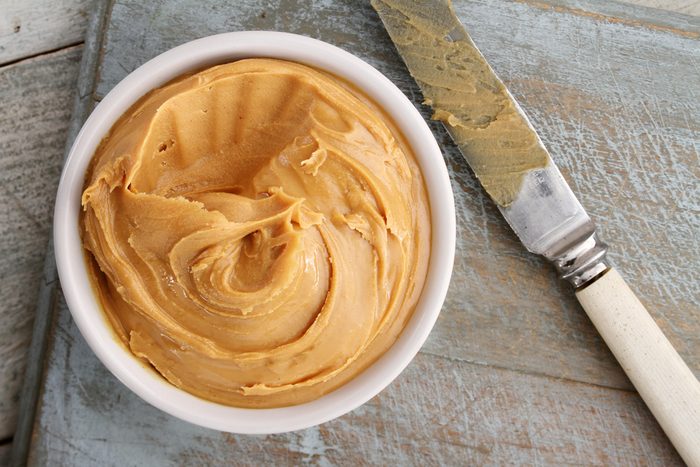 peanut butter in bowl with knife