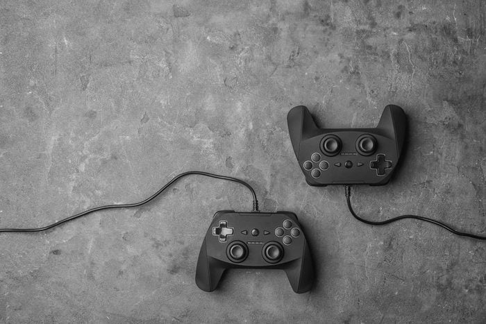 Video game controllers on grey background