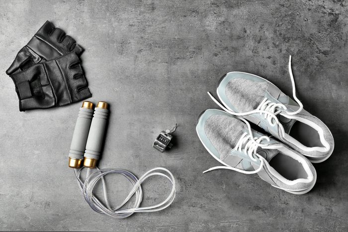 Weight-lifting gloves, jump rope, stopwatch, and sneakers