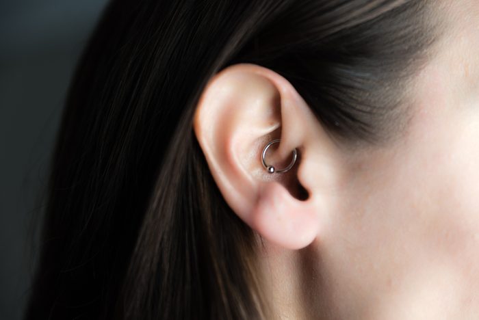 medicinal earring in ear to treat headaches