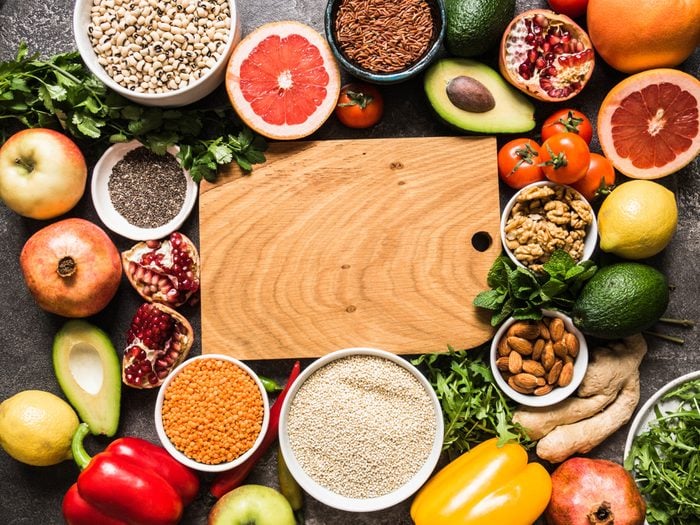 Fresh raw ingredients for healthy cooking. Vegetables, fruit, seeds, cereals, beans, spices, superfoods, herbs. Clean food. Top view. Diet or vegetarian food concept. Copy space