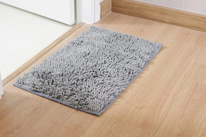 Fluffy gray doormat on the wood floor