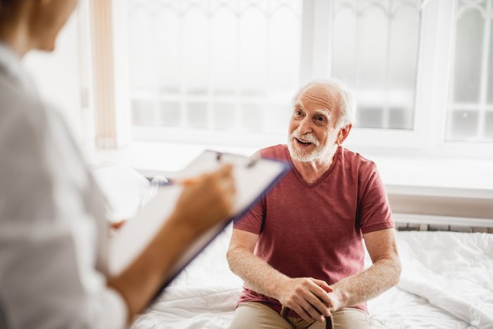 senior patient talking to health care worker