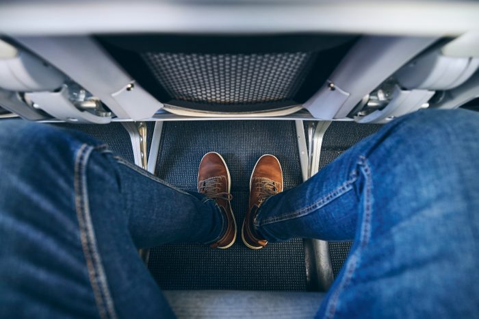 man legroom seats shoes feet airplane aisle